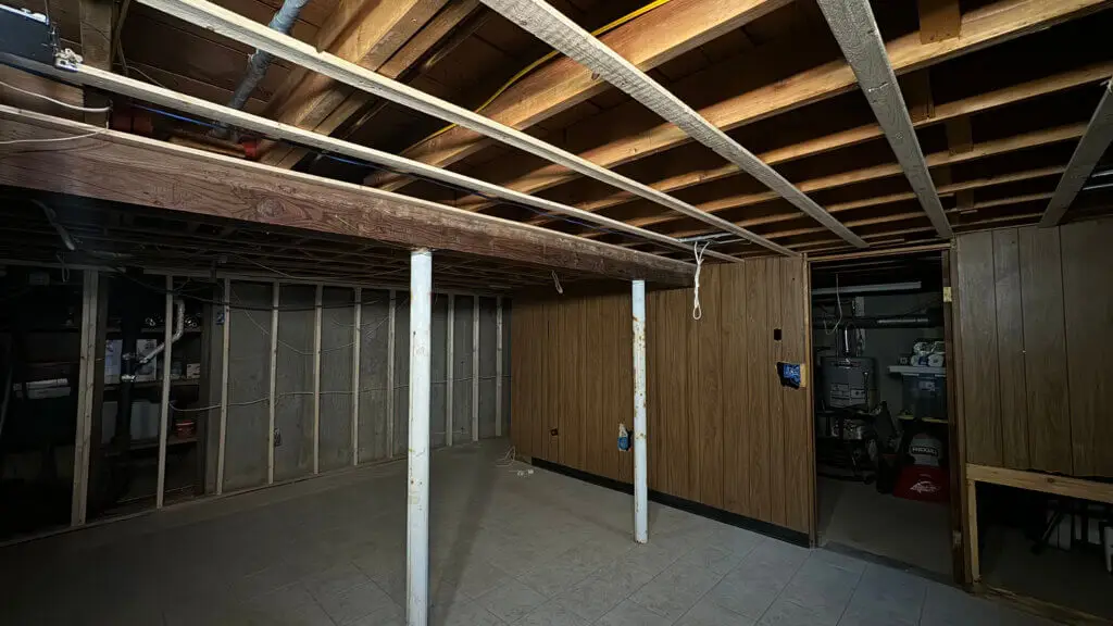 A room with wood beams and a wood wall